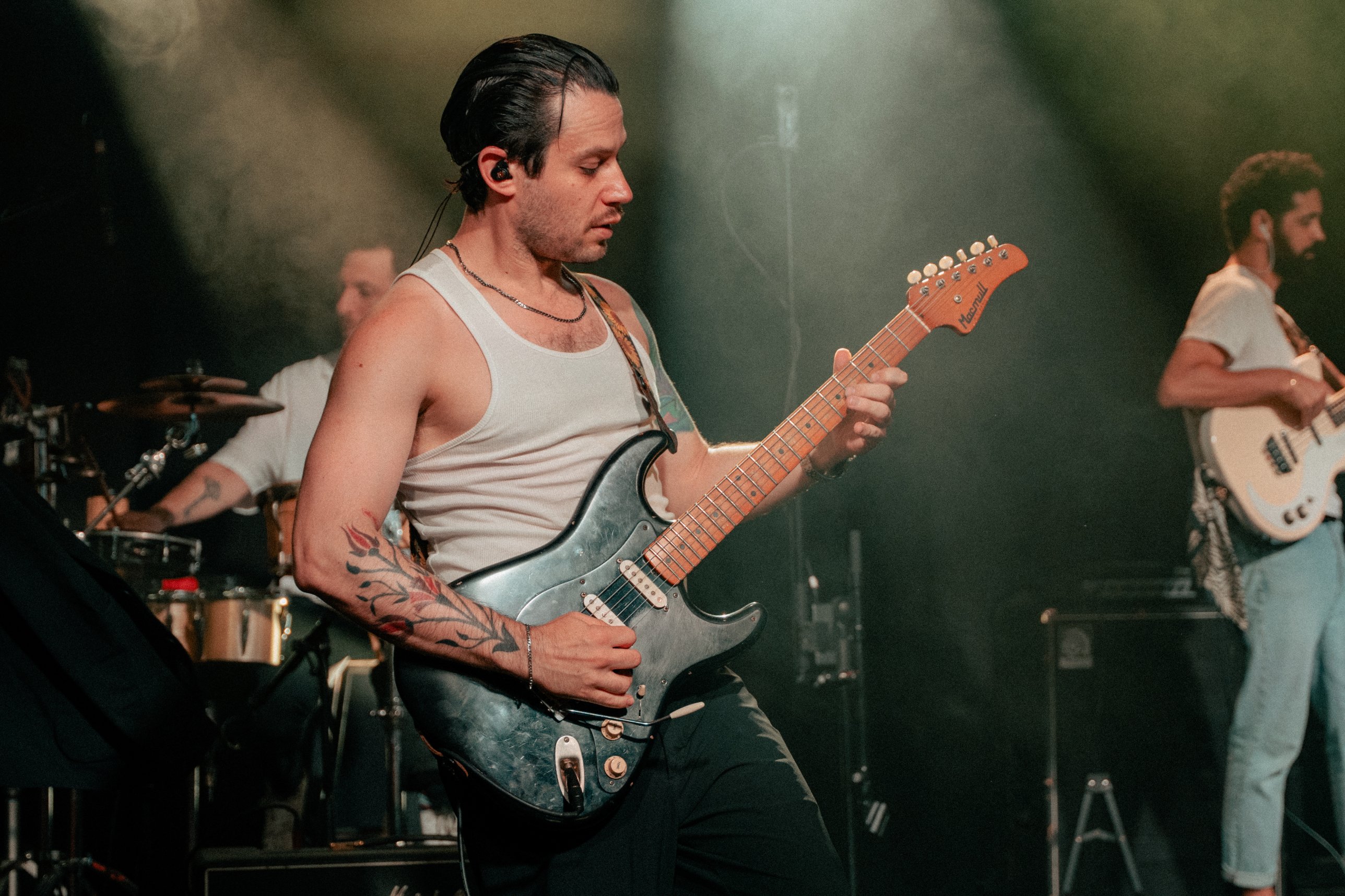 YUZ mid-solo with drums and bass behind him